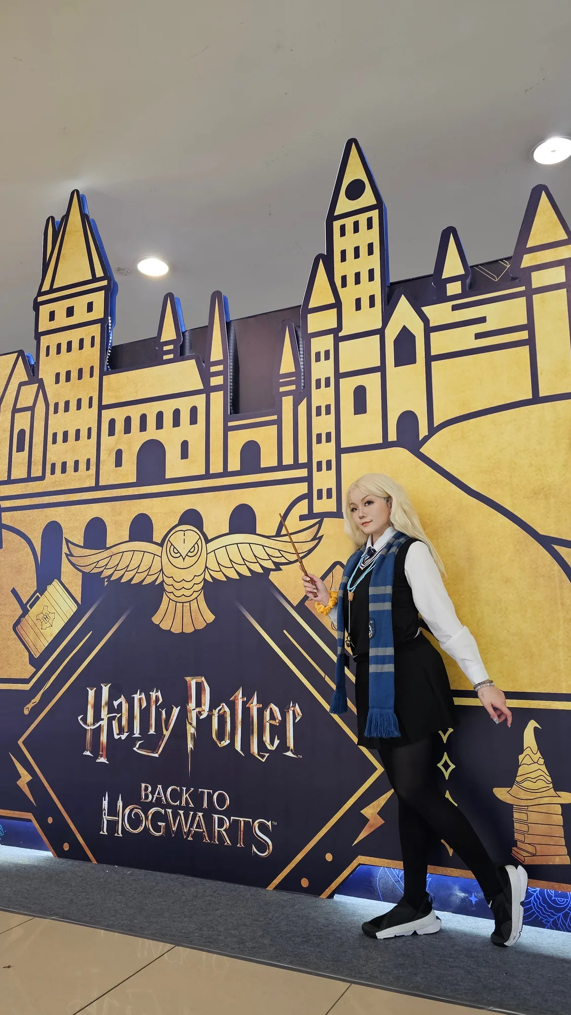 Katz posing in cosplay against a convention backdrop